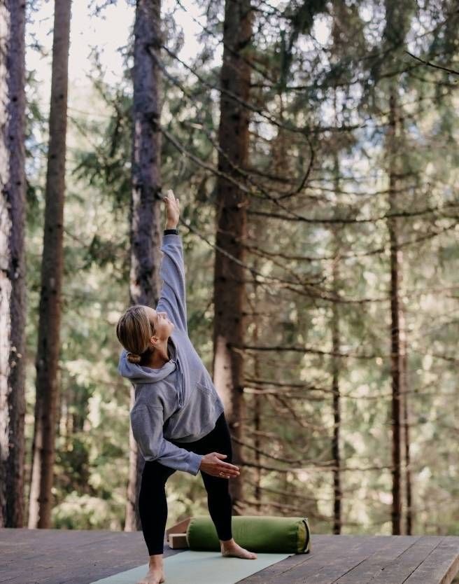 Abstract figure stretching in a soft green morning scene